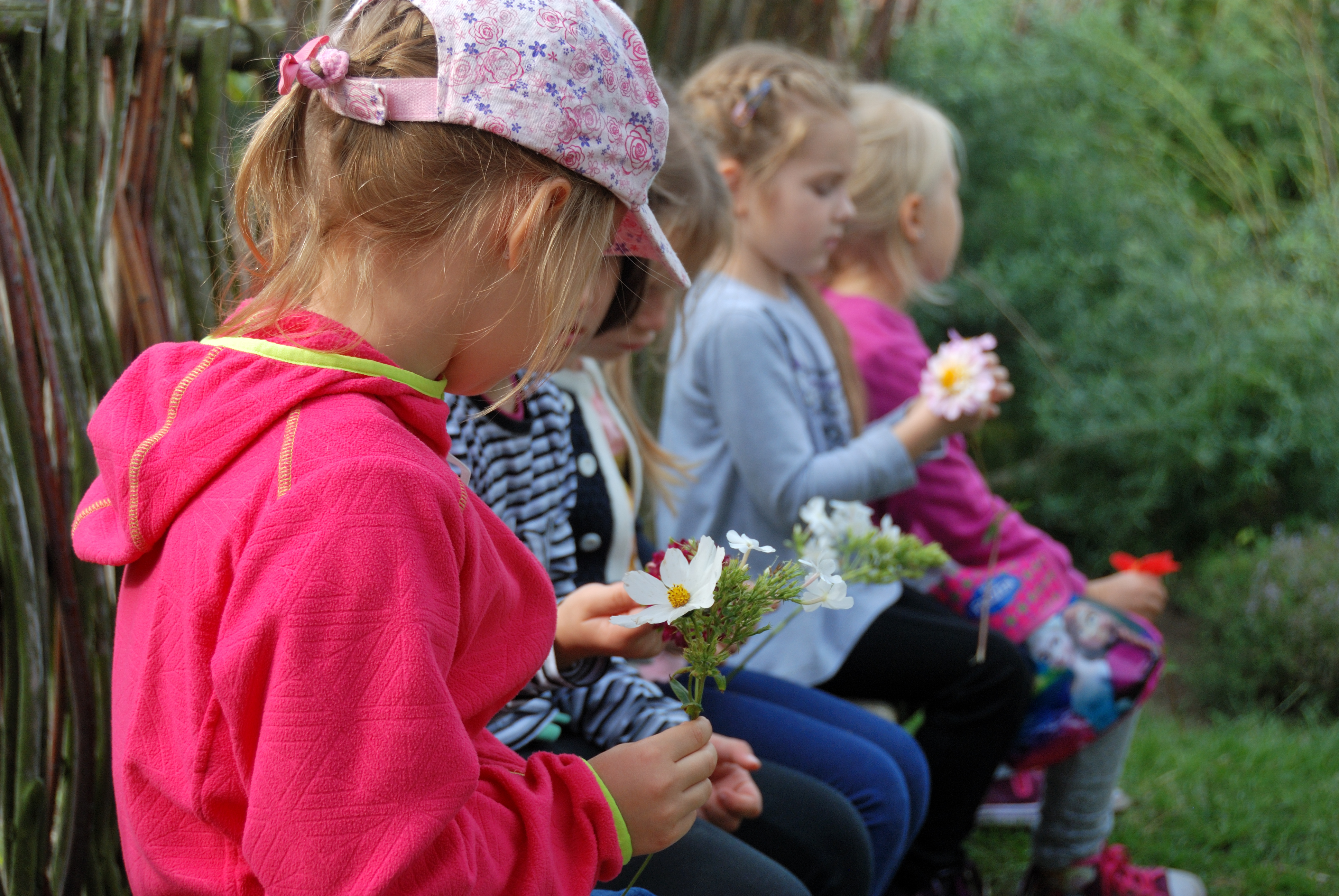 Dzieci w zagrodzie wiejskiej, poznają kwiaty rosnące dawniej w ogrodach - Skansen w Sierpcu